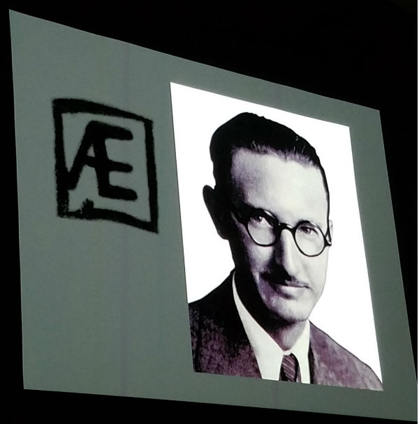 Black and white portrait with AE symbol.