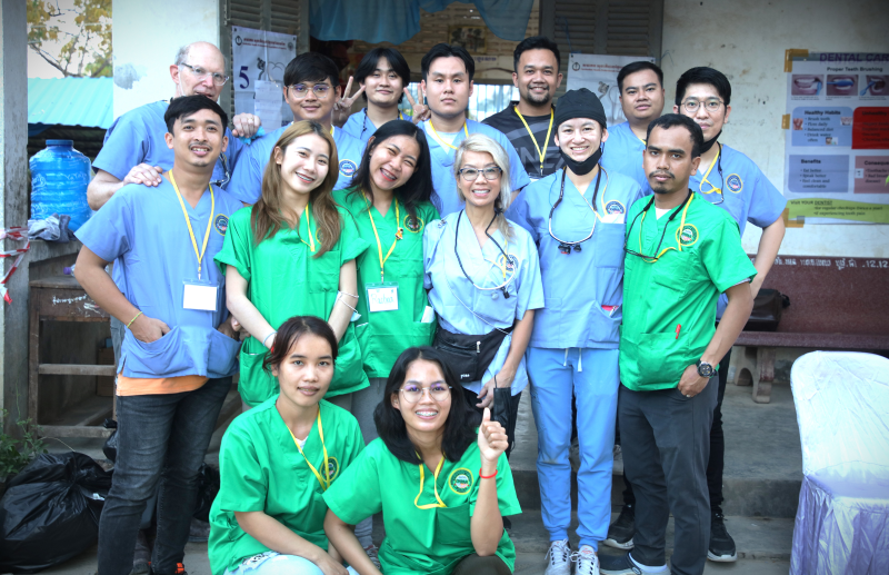 Group of healthcare professionals posing together outside.
