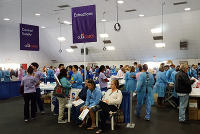 Dental care event with people and staff in scrubs.